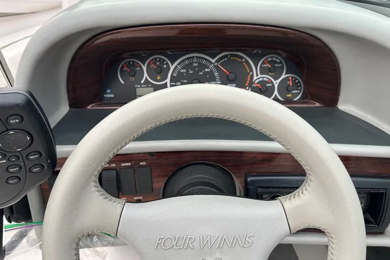 Slide: The Image of Steering wheel and dashboard of 2000 Four Winns 200 Horizon boat. - 7
