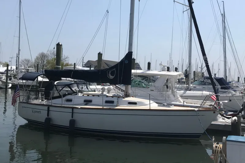 Slide: The Image of Sailboat docked at marina, Tartan 3100 model, 1994, with American flag. - 1