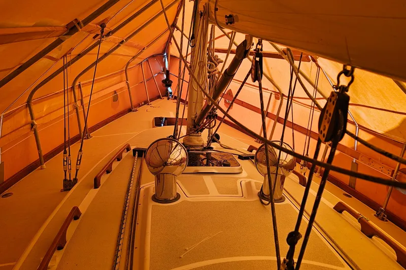 Slide: The Image of Interior view of a 1994 Tartan 3100 sailboat under orange canopy. - 18