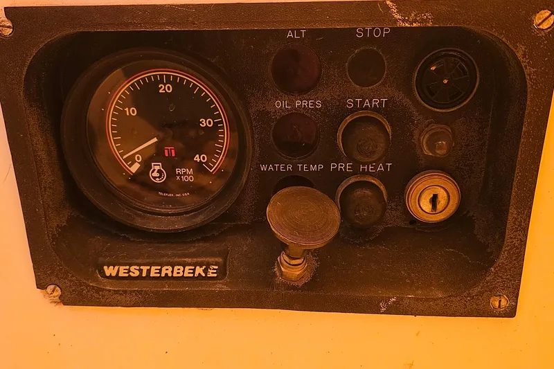 Slide: The Image of Control panel of a 1994 Tartan 3100 with RPM gauge and various switches. - 20