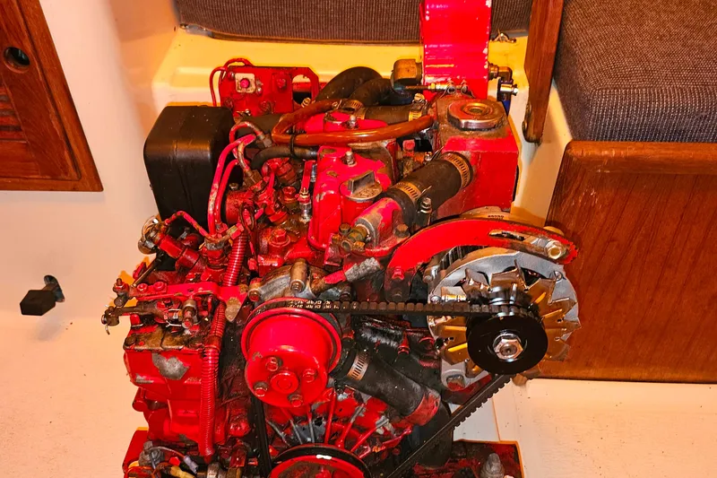 Slide: The Image of Red engine of a 1994 Tartan 3100 boat, showcasing intricate mechanical components. - 21