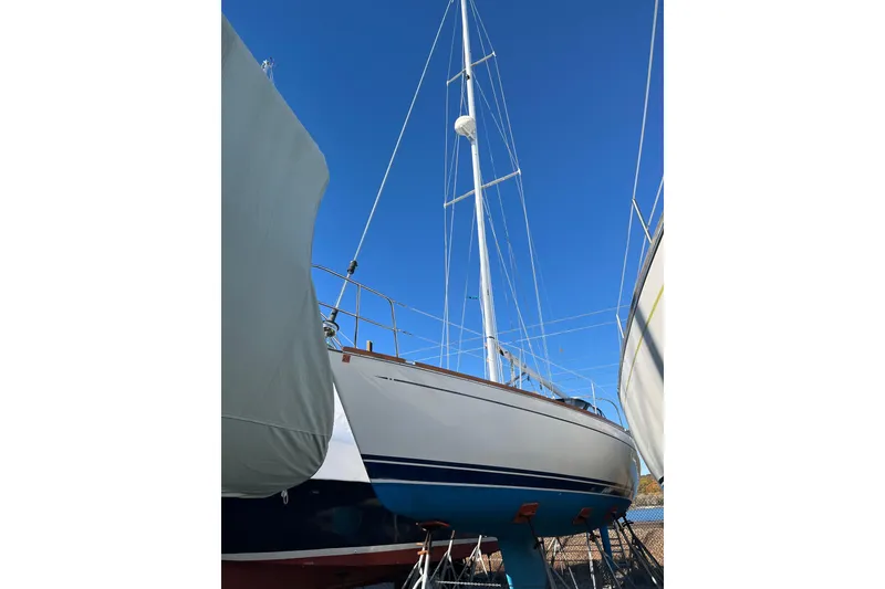 Slide: The Image of 1994 Tartan 3100 sailboat on stands, clear blue sky background. - 5