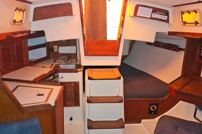Slide: The Image of Interior of a 1994 Tartan 3100 sailboat with cozy cabin and wooden finishes. - 6