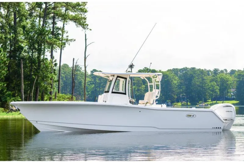 The Image of 2026 Sea Hunt Gamefish 30 Coffin Box boat on trailer, outdoor display. - 1