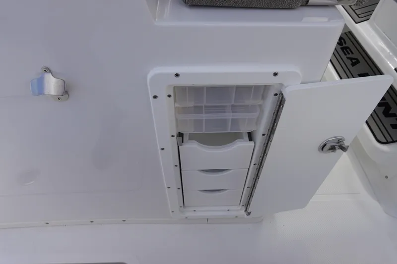 Slide: The Image of Storage compartment on 2026 Sea Hunt Gamefish 30 Coffin Box boat, featuring drawers and organizer. - 21