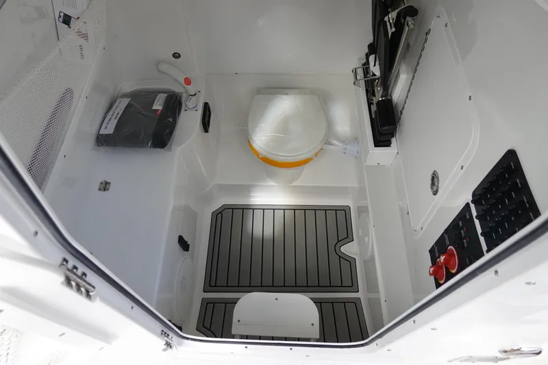 Slide: The Image of Interior of 2026 Sea Hunt Gamefish 30 Coffin Box, featuring compact marine toilet and control panel. - 46