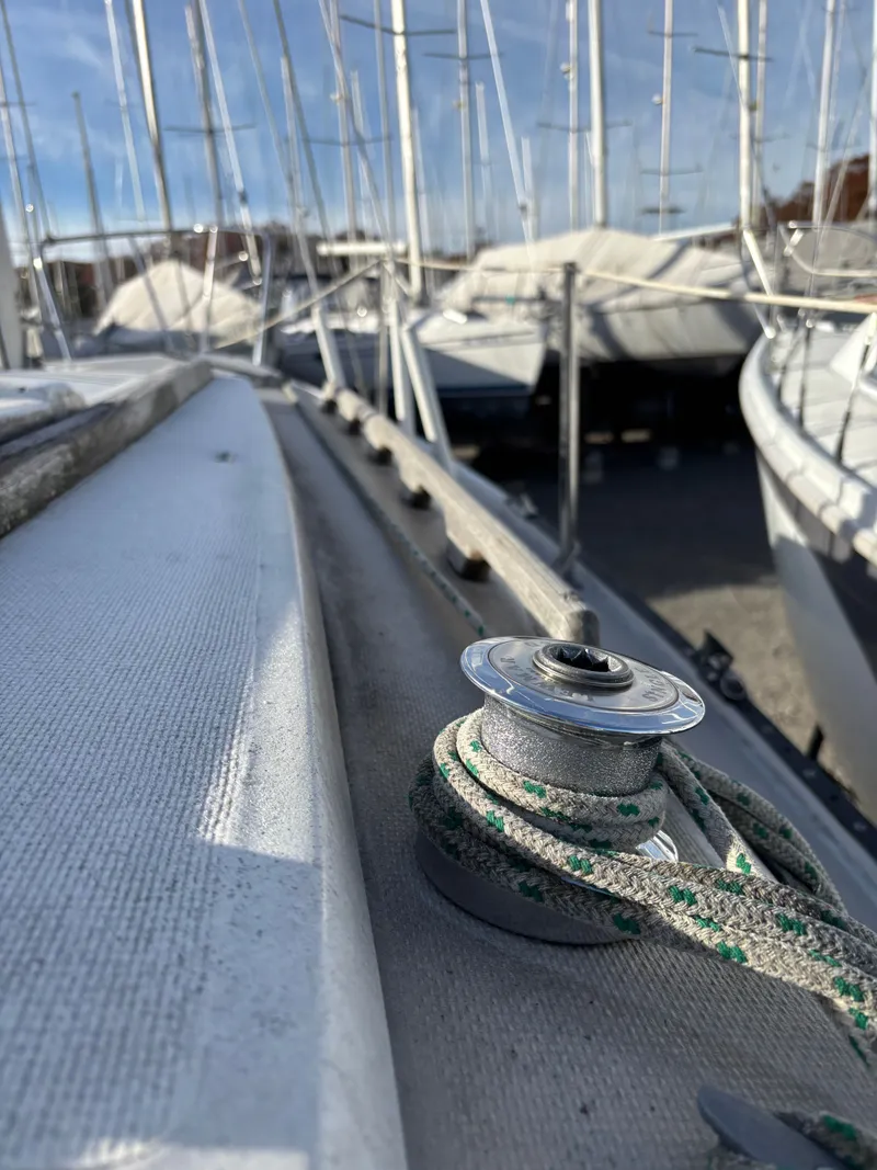 Slide: The Image of Close-up of a 1986 Catalina 25 sailboat in a marina. - 10