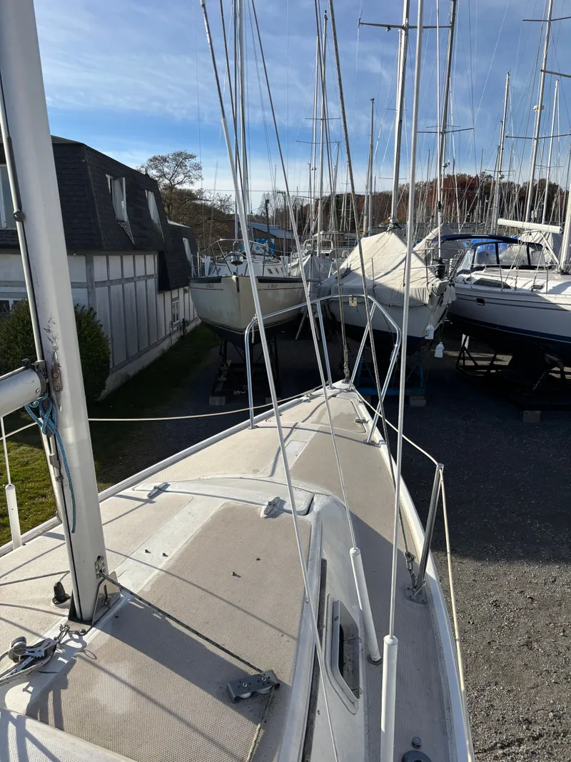 Slide: The Image of 1986 Catalina 25 sailboat in a boatyard. - 12