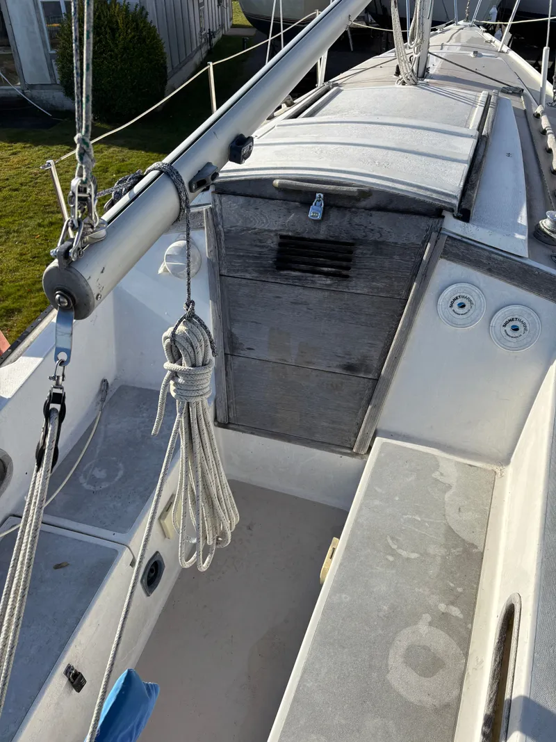 Slide: The Image of Cockpit of a 1986 Catalina 25 sailboat with ropes and wooden hatch. - 20
