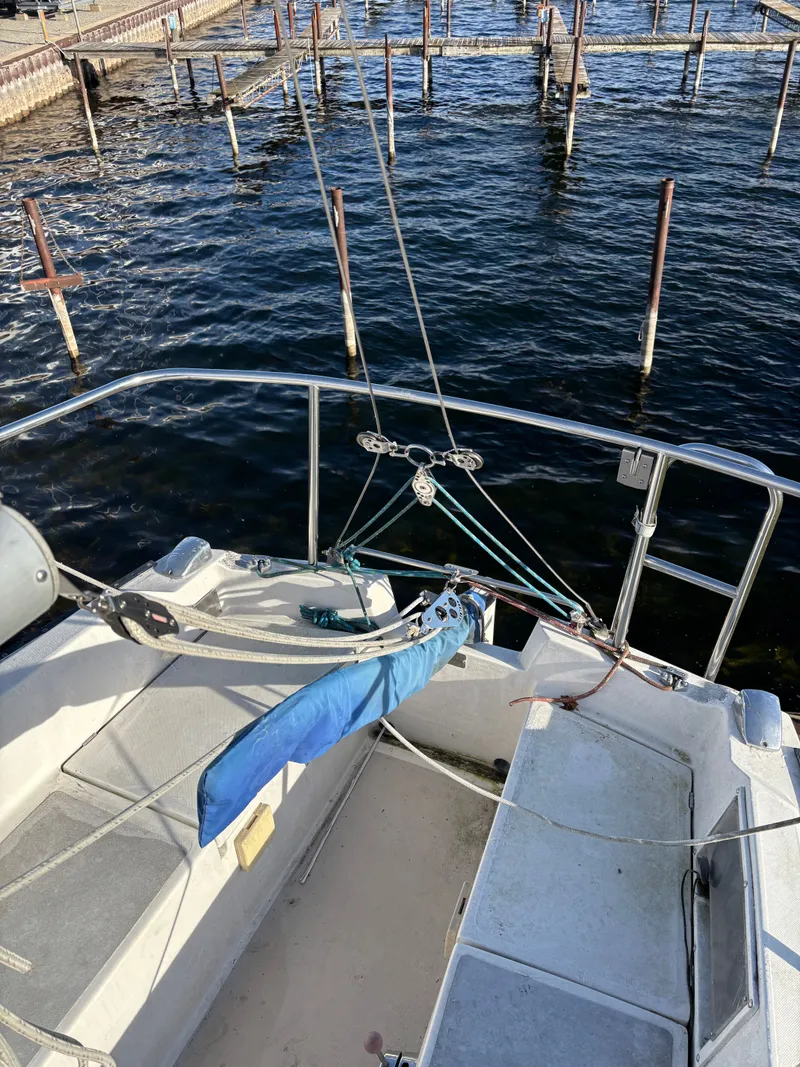Slide: The Image of 1986 Catalina 25 sailboat at dock with calm water. - 23