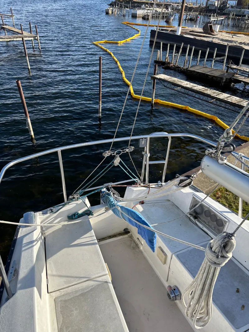 Slide: The Image of 1986 Catalina 25 sailboat docked with yellow buoy. - 24