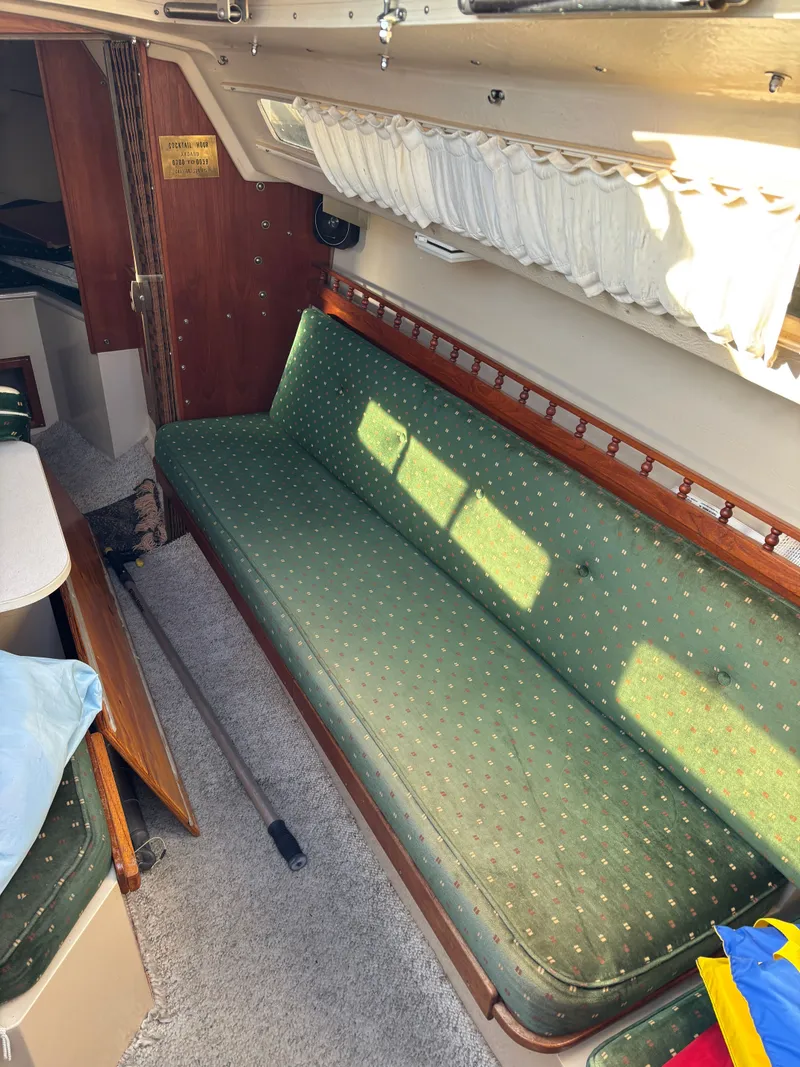 Slide: The Image of Interior of a 1986 Catalina 25 yacht with green sofa. - 40