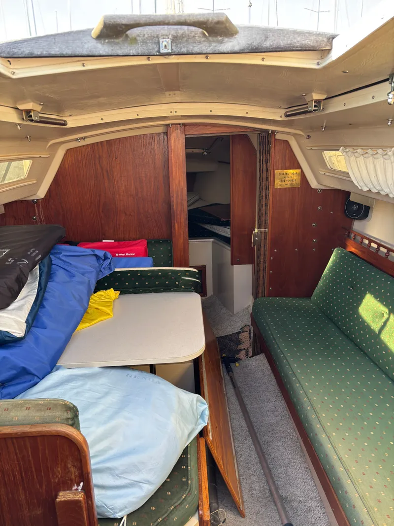 Slide: The Image of Interior of a 1986 Catalina 25 yacht with green upholstery. - 41