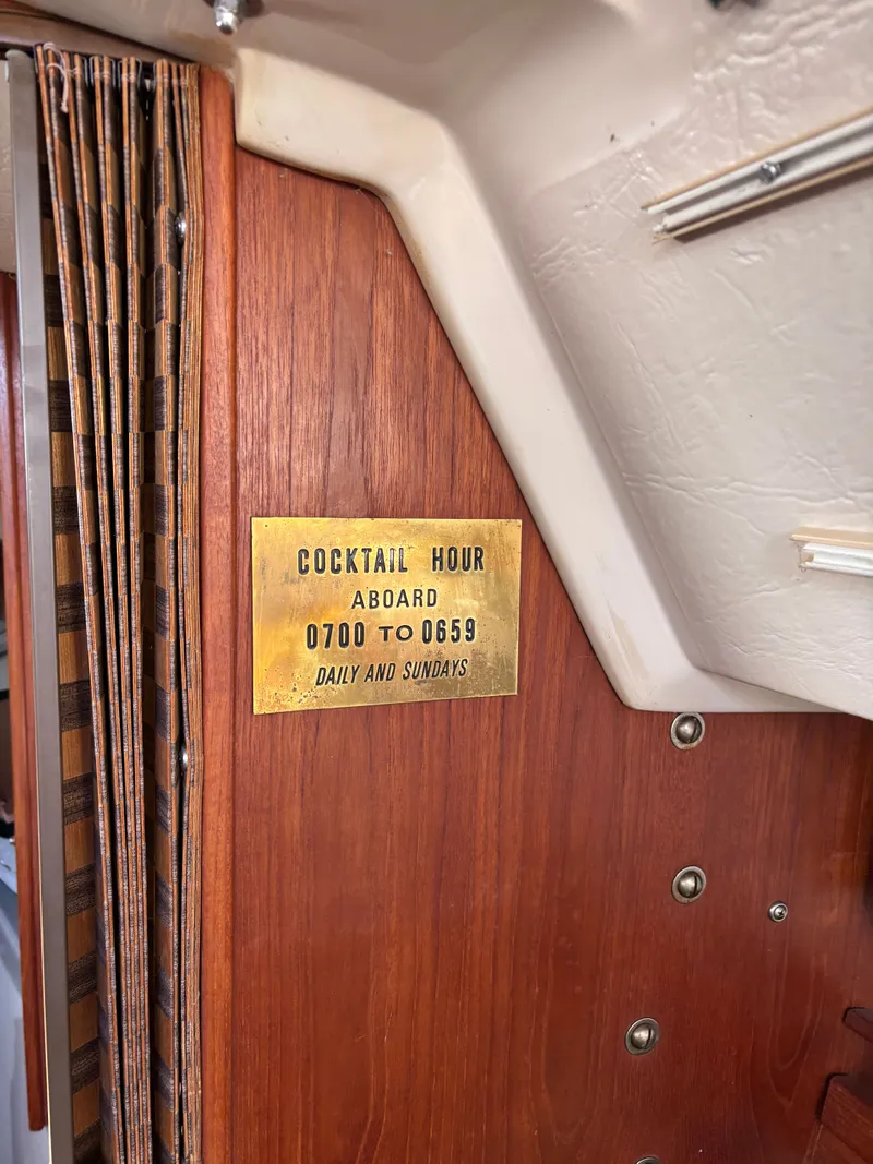 Slide: The Image of Brass plaque on Catalina 25 boat, cocktail hour daily. - 42