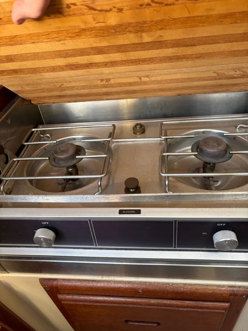 Slide: The Image of 1986 Catalina 25 sailboat alcohol stove with wooden cover. - 48