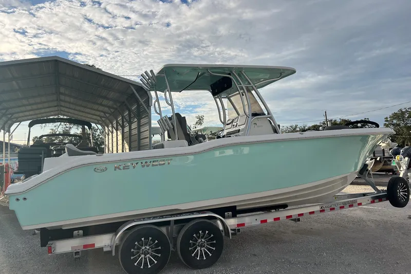 The Image of 2026 Key West 263 FS boat on trailer under a partly cloudy sky. - 1