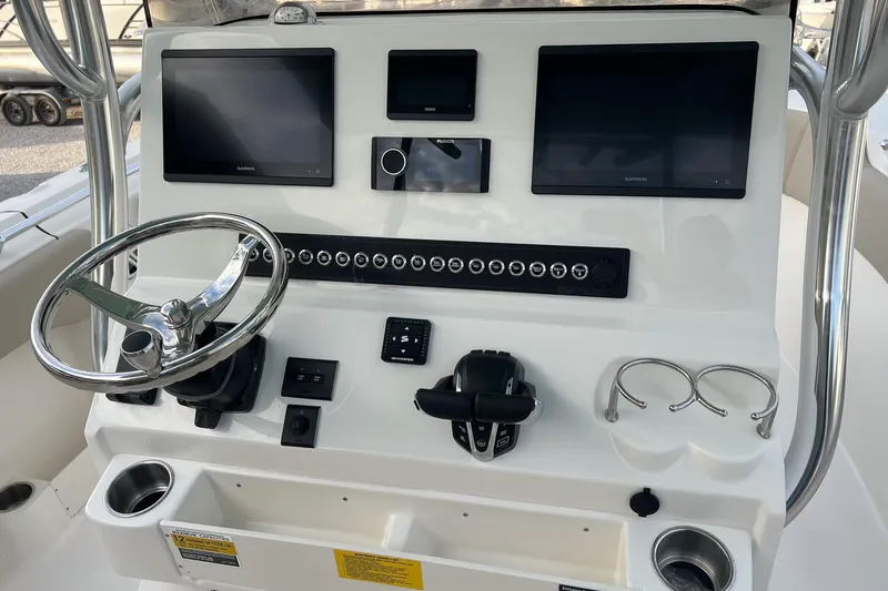 Slide: The Image of 2026 Key West 263 FS boat dashboard with steering wheel and electronic displays. - 10