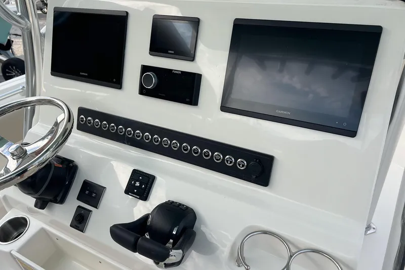 Slide: The Image of 2026 Key West 263 FS boat dashboard with Garmin displays and control panel. - 11