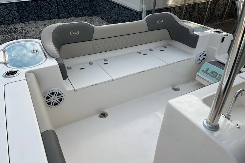 Slide: The Image of 2026 Key West 263 FS boat interior with cushioned seating and built-in speakers. - 14