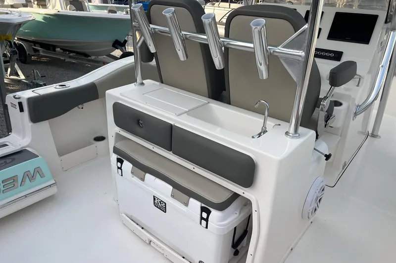 Slide: The Image of 2026 Key West 263 FS boat interior with seating, rod holders, and storage. - 19