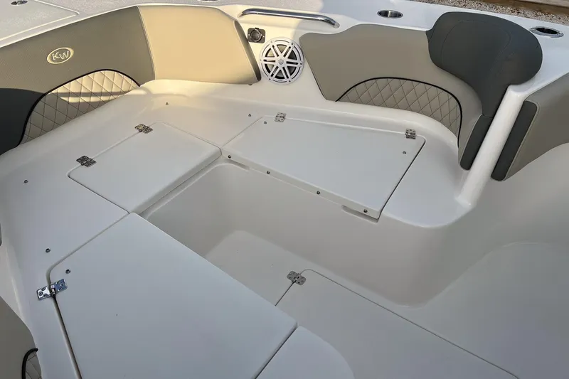 Slide: The Image of 2026 Key West 263 FS boat interior with storage compartments and cushioned seating. - 25