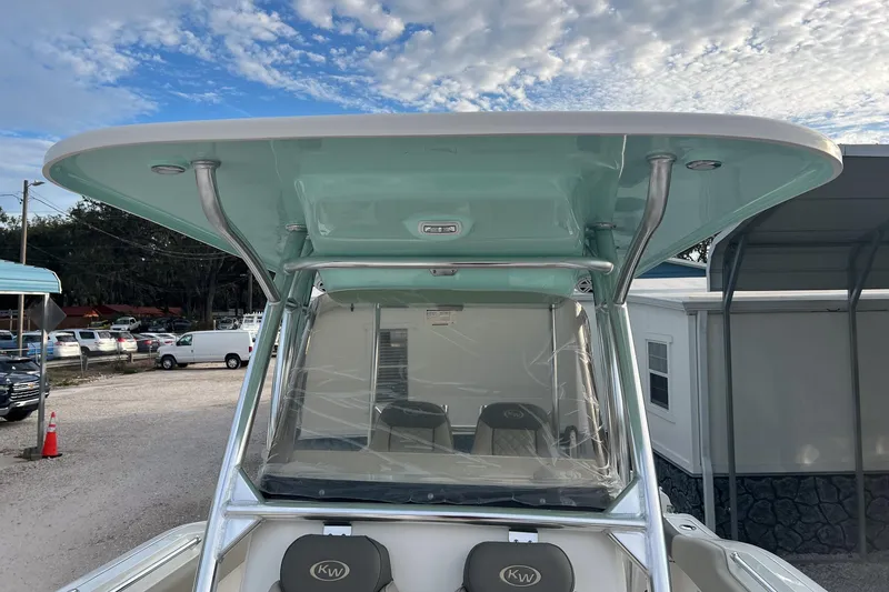 Slide: The Image of 2026 Key West 263 FS boat with T-top and seating, parked outdoors. - 29