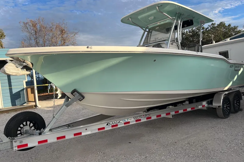 Slide: The Image of 2026 Key West 263 FS boat on trailer, light blue hull, parked outdoors. - 4