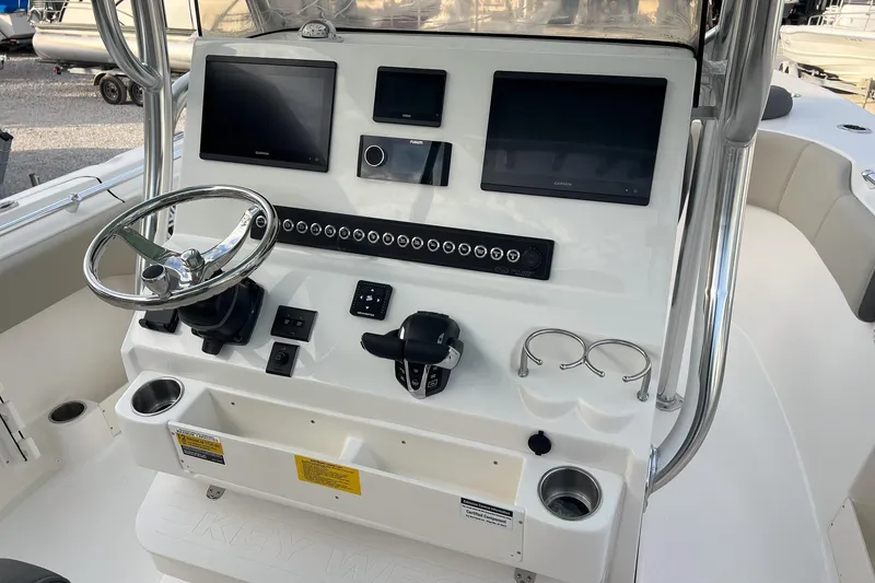Slide: The Image of 2026 Key West 263 FS boat console with steering wheel and electronic displays. - 9
