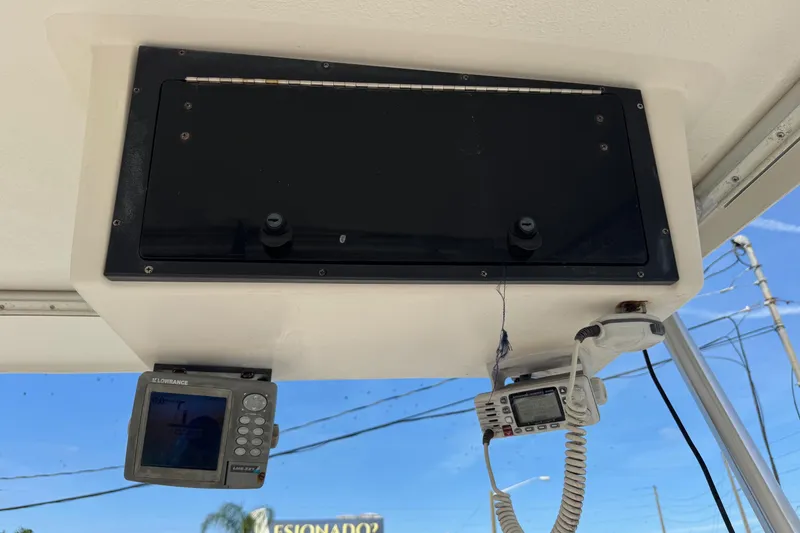 Slide: The Image of 2006 Mako 253 Walk Around boat dashboard with navigation and communication equipment. - 11