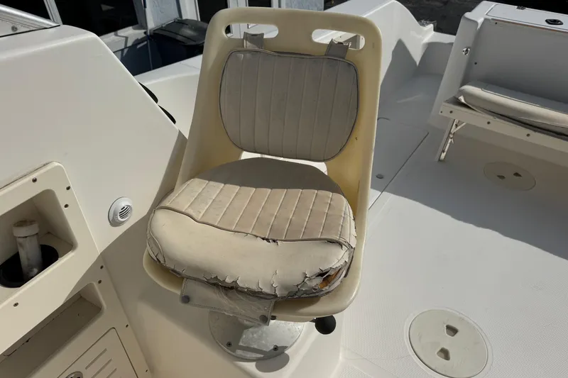Slide: The Image of Worn captain's chair on 2006 Mako 253 Walk Around boat deck. - 18