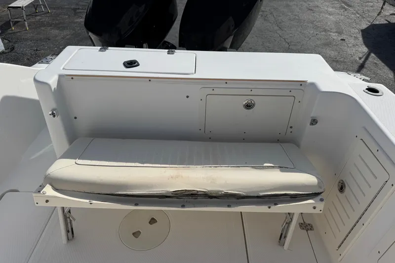 Slide: The Image of 2006 Mako 253 Walk Around boat interior with seating and storage compartments. - 19