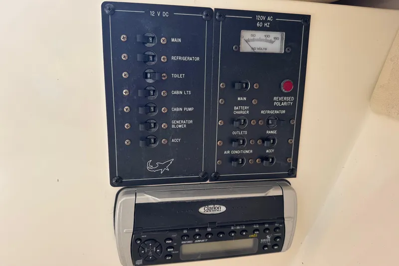 Slide: The Image of Electrical control panel and radio on a 2006 Mako 253 Walk Around boat. - 26