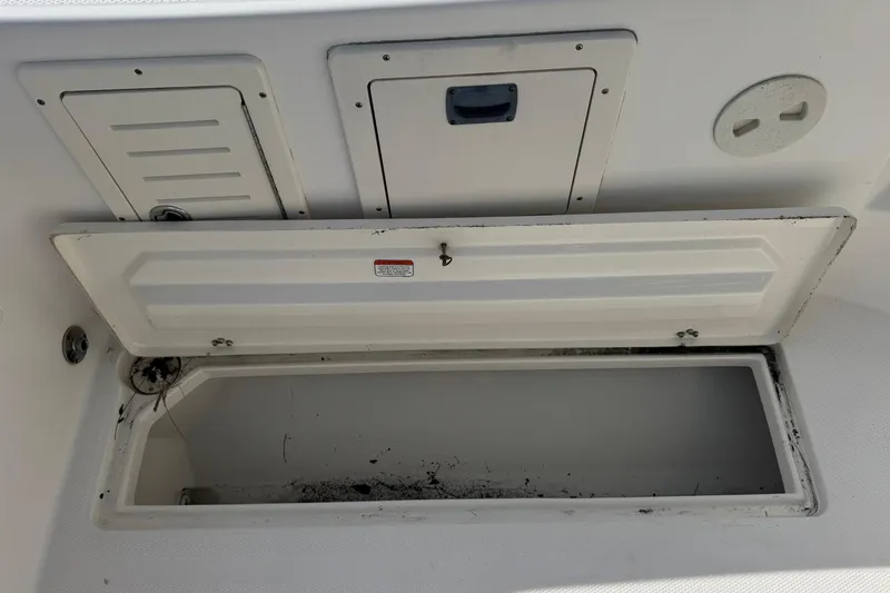 Slide: The Image of Open storage compartment on a 2006 Mako 253 Walk Around boat. - 38