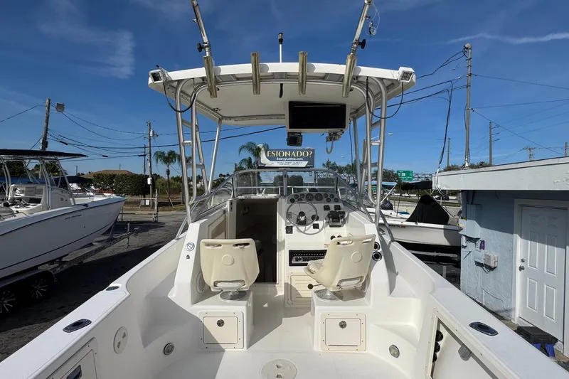 Slide: The Image of 2006 Mako 253 Walk Around boat with dual seats and steering console. - 4