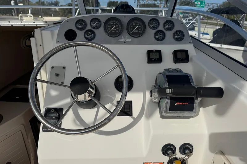 Slide: The Image of Steering console of 2006 Mako 253 Walk Around boat with Mercury controls. - 5