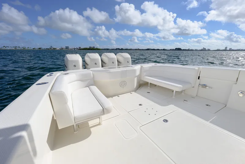 Slide: The Image of 2017 SeaVee 390Z boat deck with seating, ocean view, and clear sky. - 12
