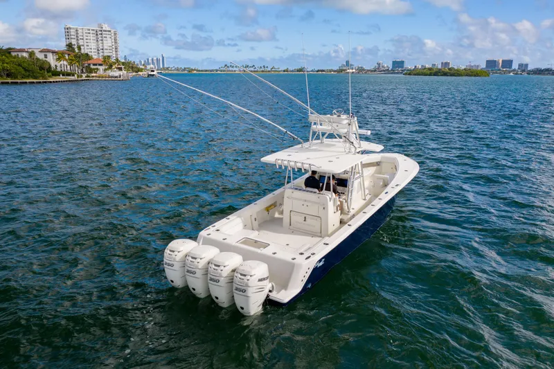 Slide: The Image of 2017 SeaVee 390Z boat with four engines cruising on a sunny day. - 2
