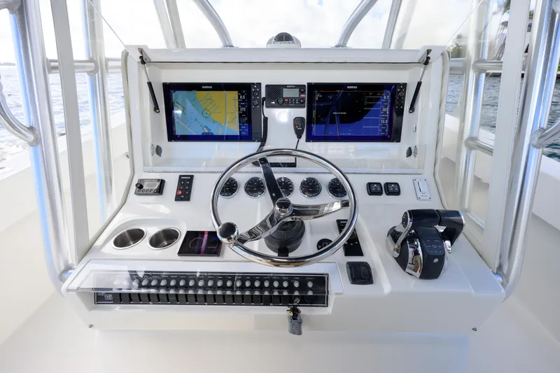 Slide: The Image of 2017 SeaVee 390Z boat dashboard with dual screens, steering wheel, and controls. - 6