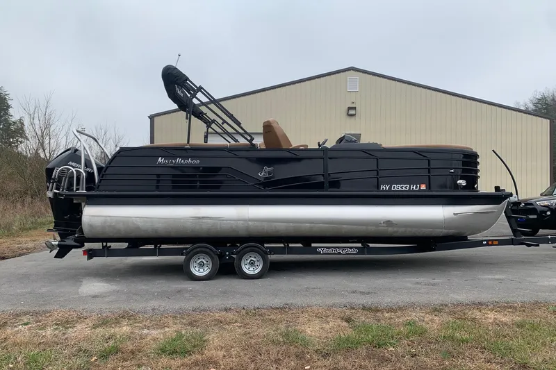 Slide: The Image of 2020 Misty Harbor Elite E3U pontoon boat on trailer, parked outdoors. - 1