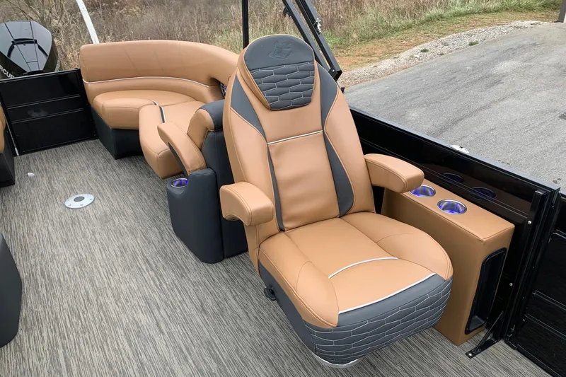 Slide: The Image of Luxurious seating on 2020 Misty Harbor Elite E3U pontoon boat, featuring tan and gray upholstery. - 11