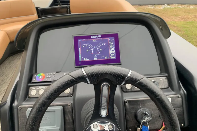 Slide: The Image of Steering console of 2020 Misty Harbor Elite E3U with Simrad display and controls. - 13
