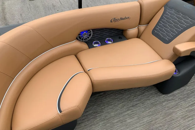 Slide: The Image of Luxurious tan seating on 2020 Misty Harbor Elite E3U boat with cup holders and speaker. - 14
