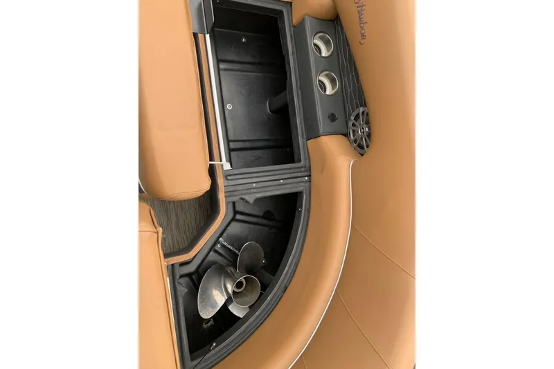 Slide: The Image of 2020 Misty Harbor Elite E3U boat interior with tan seating and storage compartment. - 16