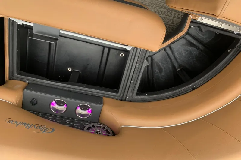 Slide: The Image of 2020 Misty Harbor Elite E3U boat interior with tan seating and cup holders. - 17
