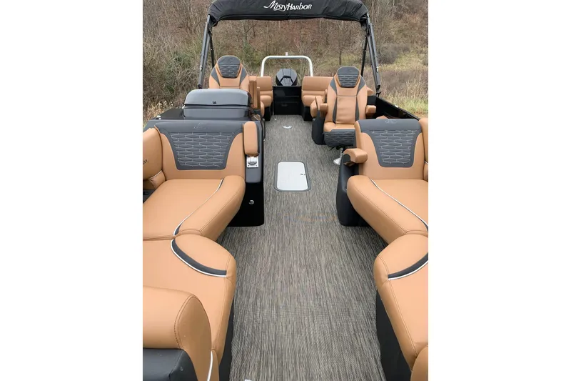 Slide: The Image of 2020 Misty Harbor Elite E3U pontoon boat interior with tan and black seating. - 9