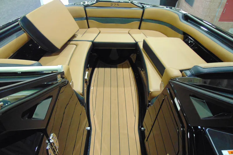 Slide: The Image of 2026 Yamaha Boats 275SD interior with tan seating and sleek wooden flooring. - 14