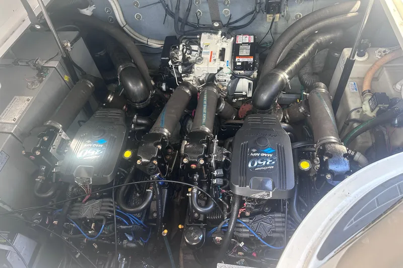 Slide: The Image of 2004 Sea Ray 320 Sundancer cabin interior with bed, TV, and wood cabinetry. - 12