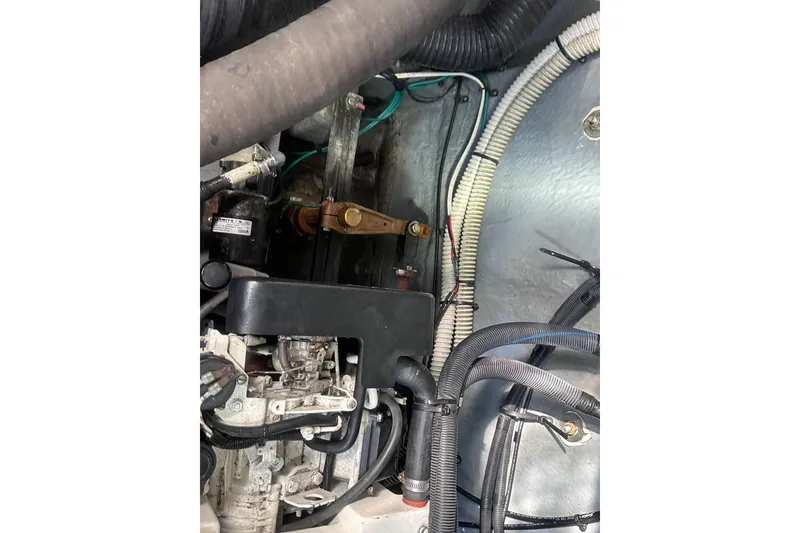 Slide: The Image of Engine compartment of a 2004 Sea Ray 320 Sundancer boat, showing various components and wiring. - 17