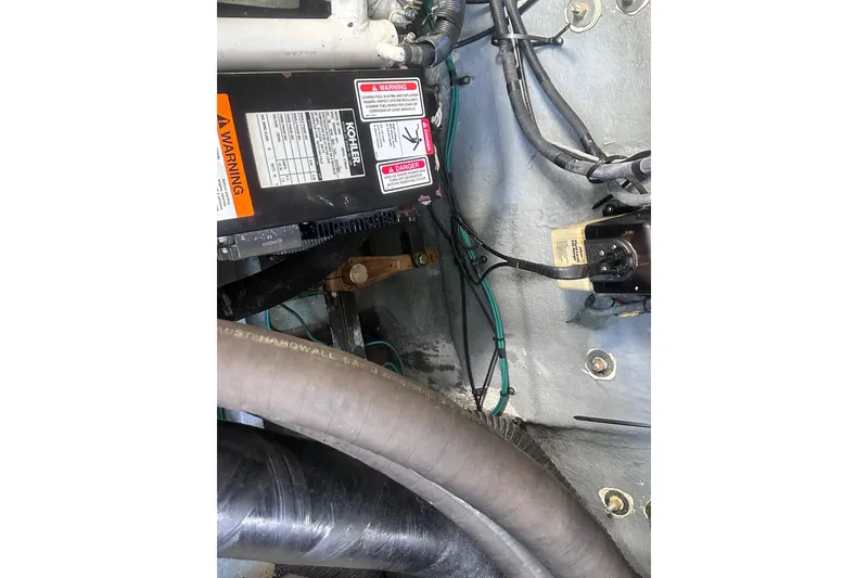 Slide: The Image of Engine compartment of 2004 Sea Ray 320 Sundancer with wiring and components visible. - 19