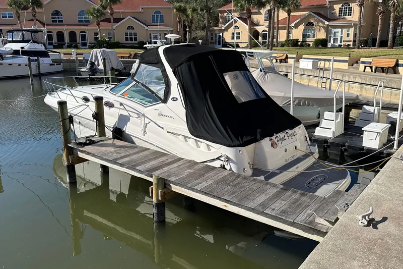 Slide: The Image of 2004 Sea Ray 320 Sundancer docked at marina with black cover. - 20